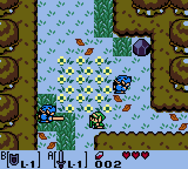 Still frame: a forest screen with a yellow flower bed. Link is at the bottom, and two blue Moblins are nearby.